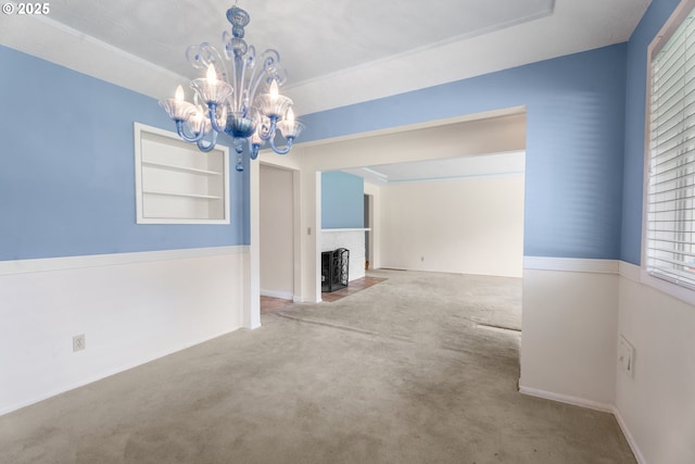 1604 NE 153rd Pl, Portland, OR 97230 - unfurnished living room featuring a chandelier, carpet floors, and built in shelves