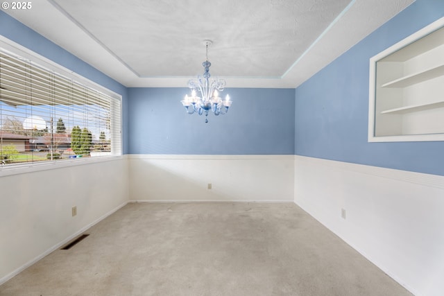 1604 NE 153rd Pl, Portland, OR 97230 - carpeted spare room featuring a tray ceiling and a chandelier