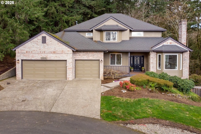 view of front of home with a garage, concrete driveway, a shingled roof, and brick siding