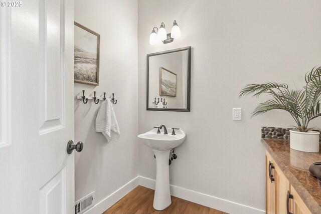 10915 SW Mourning Dove Pl, Beaverton, OR 97007 - bathroom featuring baseboards, a sink, wood finished floors, and visible vents