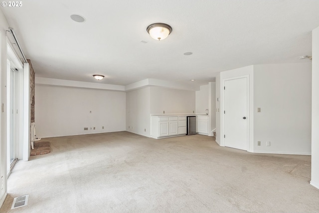 interior space featuring light carpet and visible vents