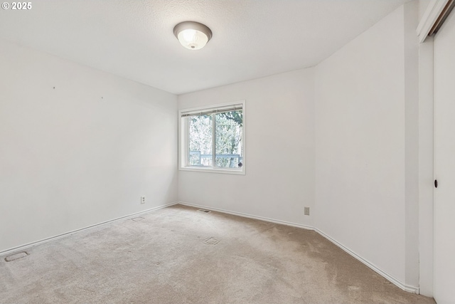 carpeted spare room with baseboards