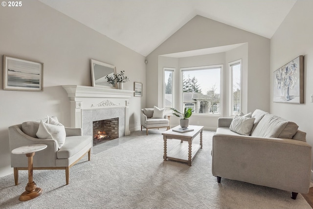 living area with vaulted ceiling, carpet floors, and a high end fireplace