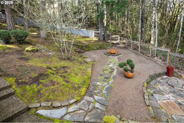 view of yard featuring fence and a fire pit