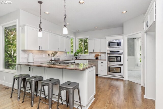 10915 SW Mourning Dove Pl, Beaverton, OR 97007 - kitchen featuring recessed lighting, a sink, appliances with stainless steel finishes, and a peninsula