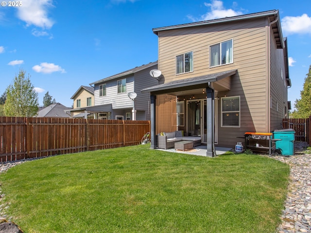 back of house featuring a yard, outdoor lounge area, a patio area, and a fenced backyard