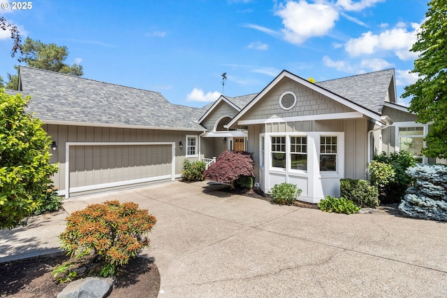 1249 Crenshaw Rd, Eugene, OR 97401 - view of front of house with an attached garage, concrete driveway, board and batten siding, and a shingled roof