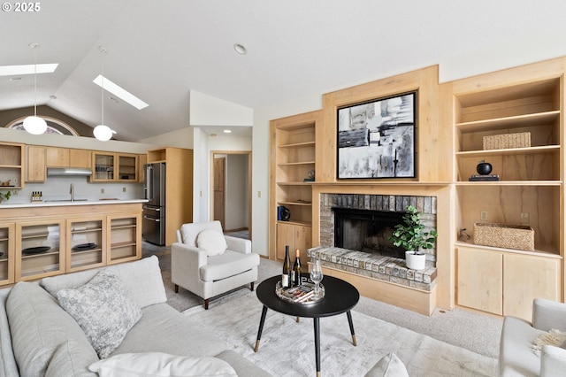 1249 Crenshaw Rd, Eugene, OR 97401 - living area featuring a skylight, light colored carpet, built in features, vaulted ceiling, and a fireplace