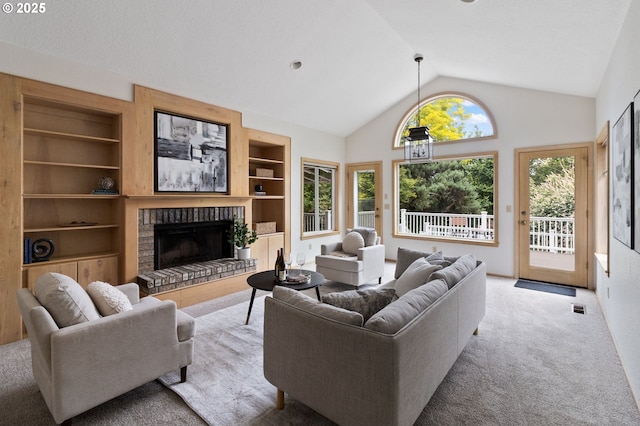 1249 Crenshaw Rd, Eugene, OR 97401 - living area with built in shelves, lofted ceiling, a fireplace, carpet floors, and plenty of natural light