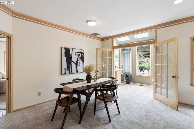 1249 Crenshaw Rd, Eugene, OR 97401 - dining room featuring ornamental molding, light colored carpet, a skylight, baseboards, and french doors