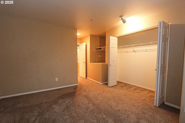 unfurnished bedroom with carpet and a closet