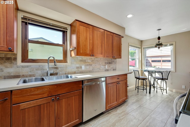 4133 SE Henderson St, Portland, OR 97202 - kitchen with stainless steel dishwasher, baseboards, brown cabinetry, and a sink