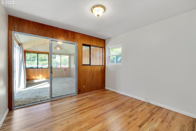 4133 SE Henderson St, Portland, OR 97202 - spare room with wooden walls, baseboards, and light wood-style floors