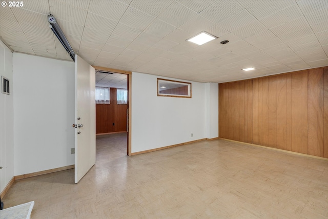 4133 SE Henderson St, Portland, OR 97202 - below grade area featuring baseboards, light floors, wooden walls, and visible vents