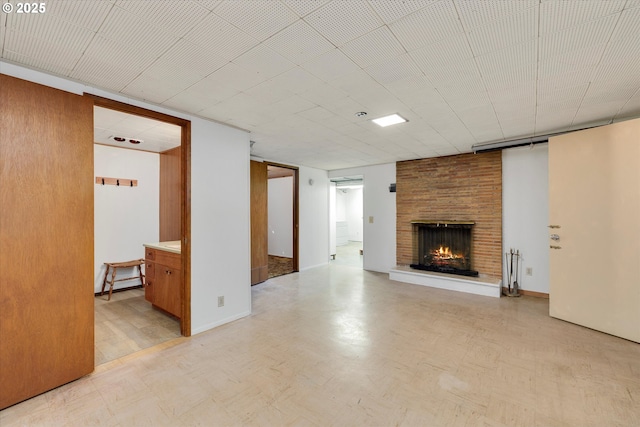 4133 SE Henderson St, Portland, OR 97202 - unfurnished living room featuring a brick fireplace and light floors