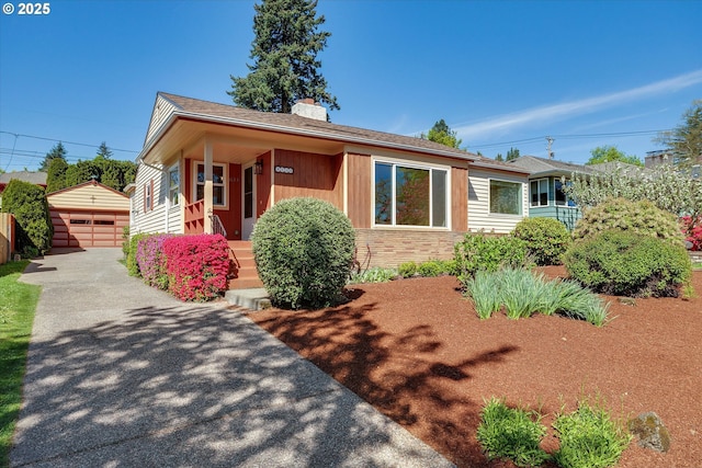 4133 SE Henderson St, Portland, OR 97202 - view of front of property featuring a garage, an outbuilding, and a chimney