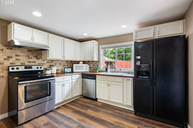 9819 SE Knight St, Portland, OR 97266 - kitchen with stainless steel appliances, under cabinet range hood, backsplash, dark wood-style floors, and white cabinets