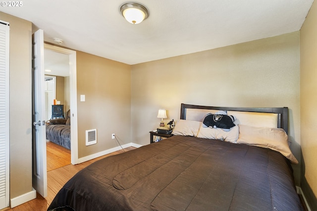 9819 SE Knight St, Portland, OR 97266 - bedroom featuring wood finished floors and heating unit