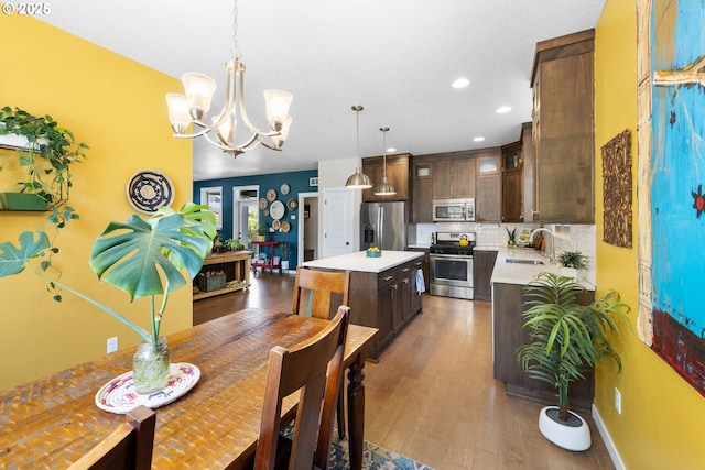 14665 Catalpa Way, Oregon City, OR 97045 - dining area featuring a chandelier, dark wood-type flooring, and recessed lighting