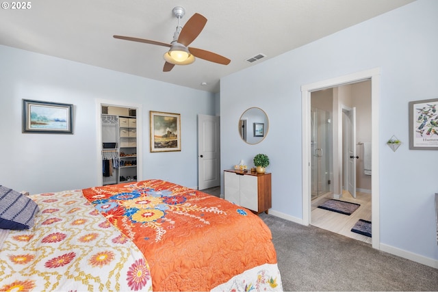14665 Catalpa Way, Oregon City, OR 97045 - carpeted bedroom featuring a walk in closet, baseboards, connected bathroom, a closet, and a ceiling fan