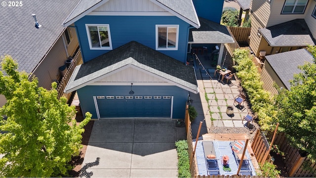 14665 Catalpa Way, Oregon City, OR 97045 - view of front facade featuring roof with shingles, driveway, board and batten siding, and a garage