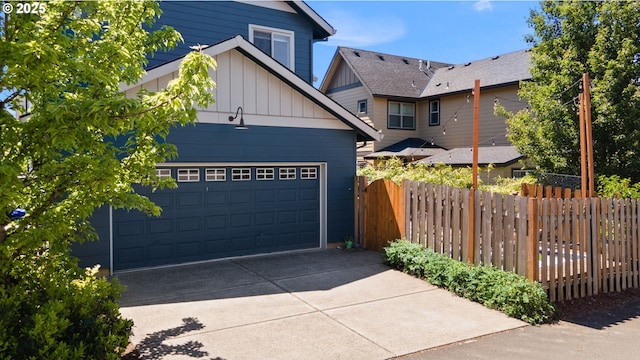 14665 Catalpa Way, Oregon City, OR 97045 - view of front of home with board and batten siding, driveway, and an attached garage