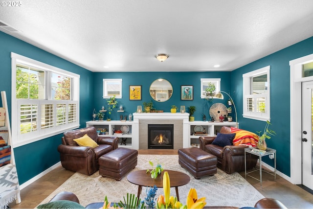 14665 Catalpa Way, Oregon City, OR 97045 - living area with baseboards, a lit fireplace, and a textured ceiling