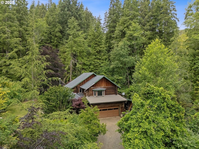 4347 S Schooner Creek Rd, Lincoln City, OR 97367 - view of front of property featuring a forest view, a garage, and dirt driveway