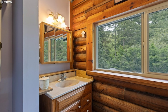 4347 S Schooner Creek Rd, Lincoln City, OR 97367 - bathroom featuring log walls, vanity, and healthy amount of natural light