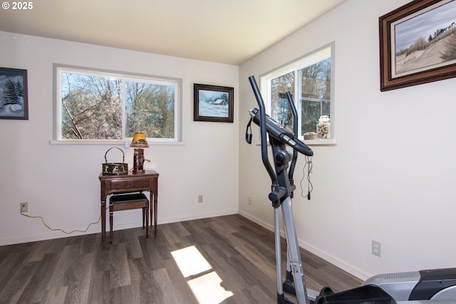 workout room with dark wood finished floors and baseboards