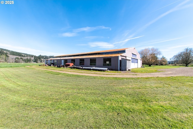 471 Barr Rd, Grays River, WA 98621 - view of front facade featuring a garage, an outdoor structure, a front lawn, and a pole building