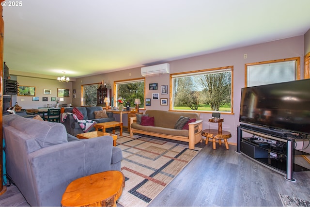 471 Barr Rd, Grays River, WA 98621 - living room with a wall mounted AC, an inviting chandelier, and wood finished floors