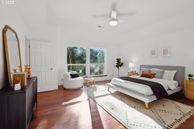 bedroom featuring dark wood-type flooring, visible vents, baseboards, and a ceiling fan