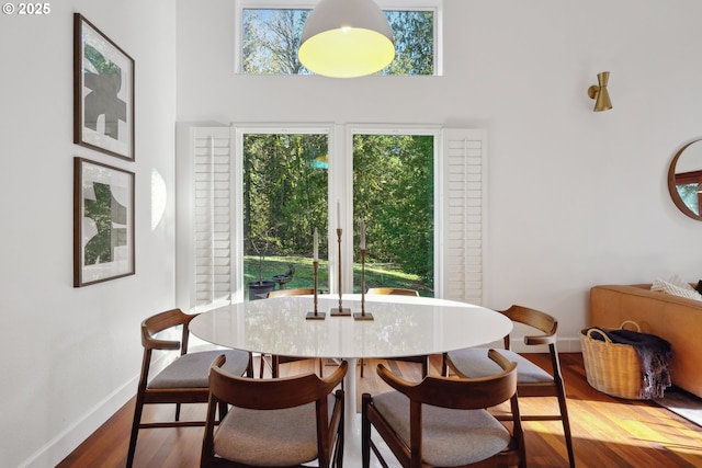 11010 SE Green Valley Rd, Sandy, OR 97055 - dining area with a high ceiling, wood finished floors, and baseboards