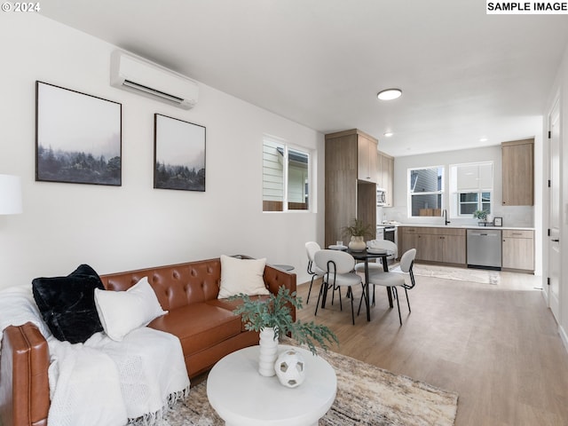 living room featuring light hardwood / wood-style flooring, an AC wall unit, and sink