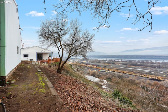 view of yard featuring a deck with mountain view