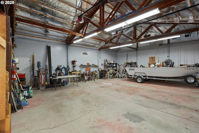 garage with a garage door opener and a workshop area