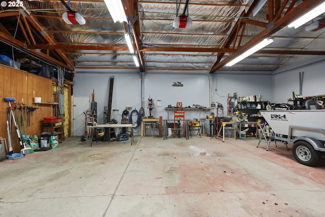 garage with a garage door opener and a workshop area