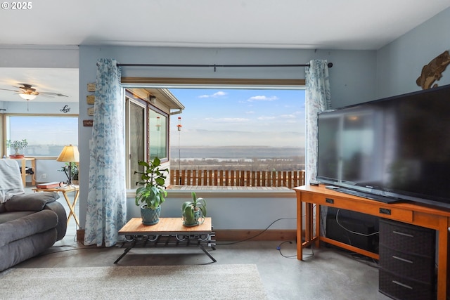 living room featuring concrete flooring and ceiling fan