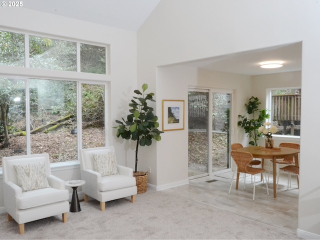 sitting room with high vaulted ceiling, baseboards, and carpet floors