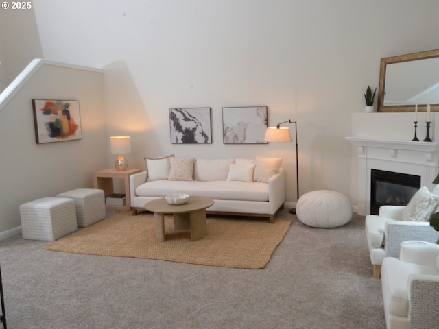 living room with carpet floors and a glass covered fireplace