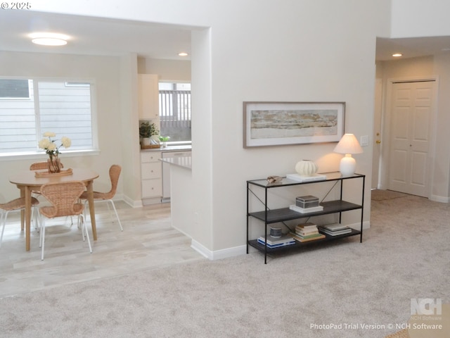 hall with light carpet, recessed lighting, and baseboards