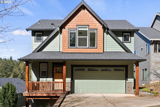 view of front of house featuring concrete driveway, roof with shingles, covered porch, a garage, and stone siding