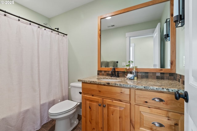 bathroom featuring visible vents, toilet, and vanity