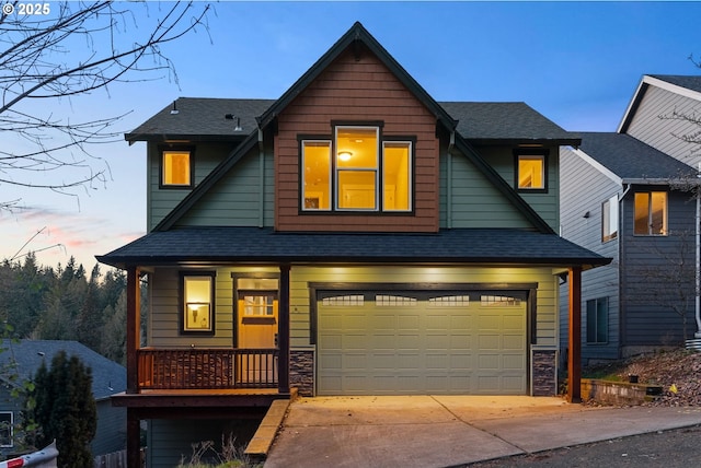 view of front of home featuring stone siding, driveway, and a shingled roof