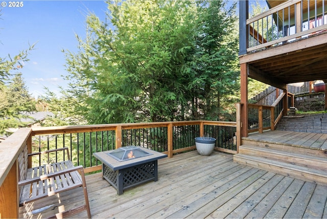 wooden terrace featuring a fire pit