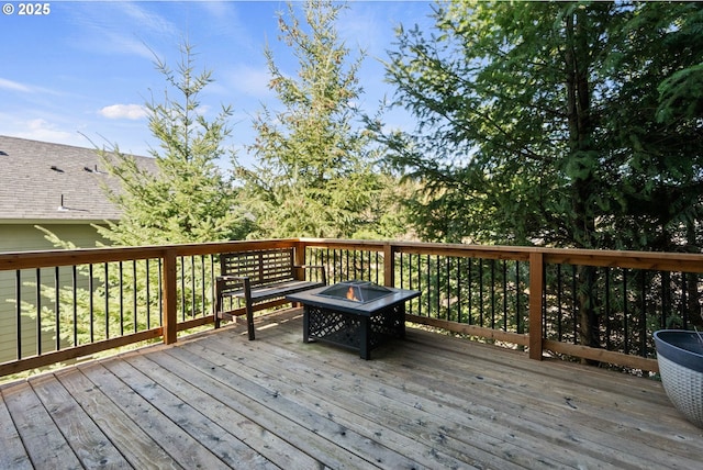 wooden terrace featuring a fire pit