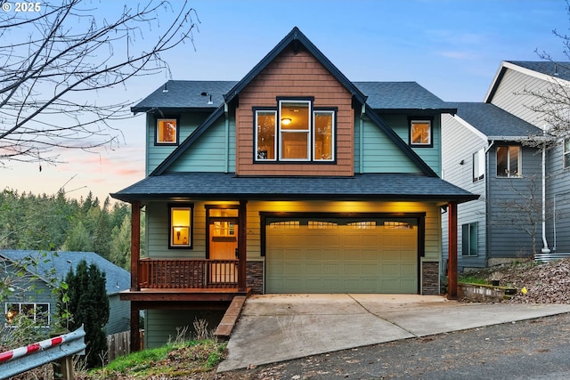 view of front of property featuring stone siding, driveway, an attached garage, and roof with shingles