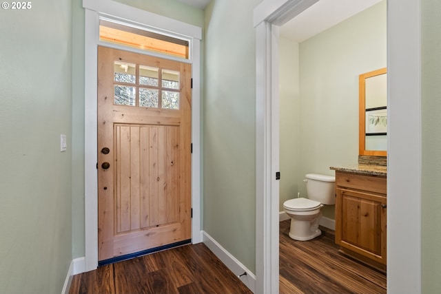 doorway to outside with baseboards and dark wood-style flooring