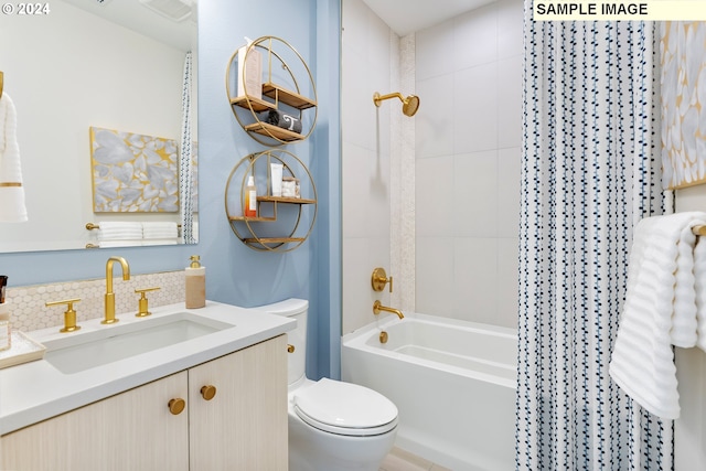 full bathroom featuring washtub / shower combination, vanity, toilet, and tasteful backsplash